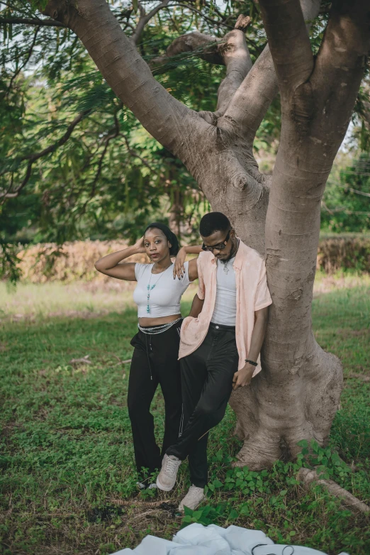 two people standing in front of some trees