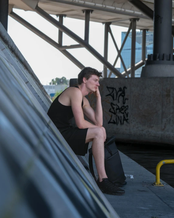 a man sitting on top of a skate board