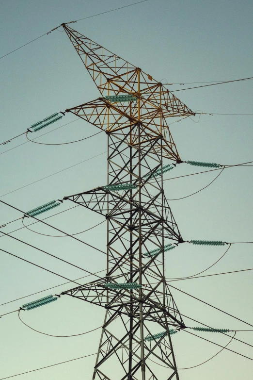 there are many power lines together on a tower