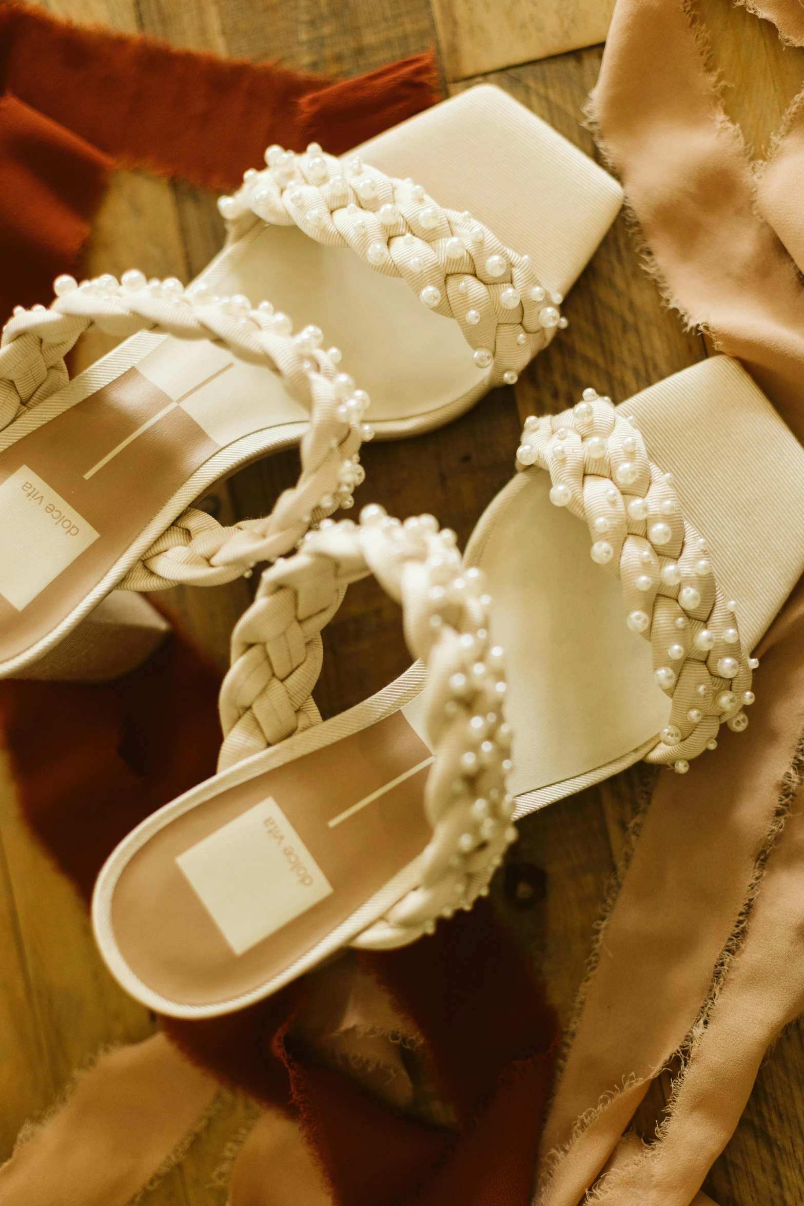 a pair of little white shoes sitting on top of a table