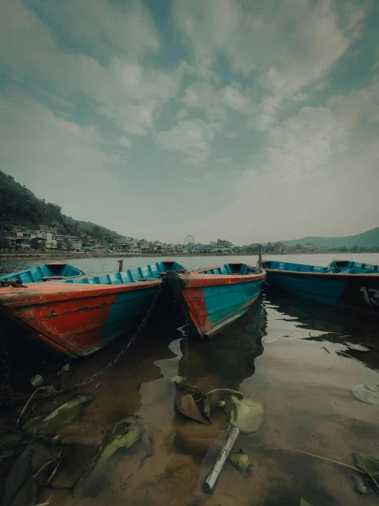 two boats parked next to each other in the water