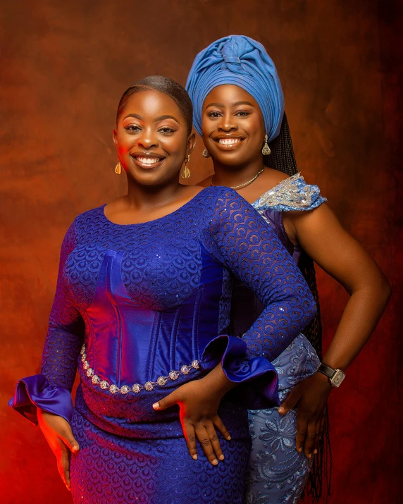 two women in blue clothing, one wearing red lipstick