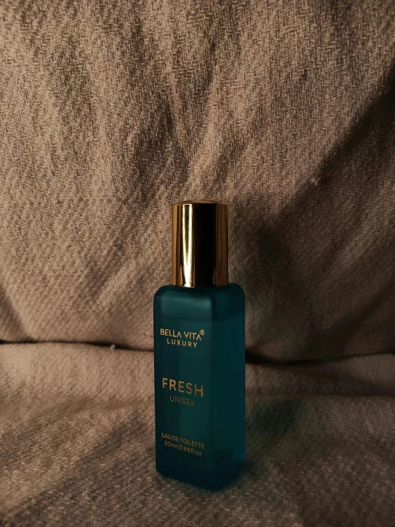 the bottle is full of fresh perfume on the bed