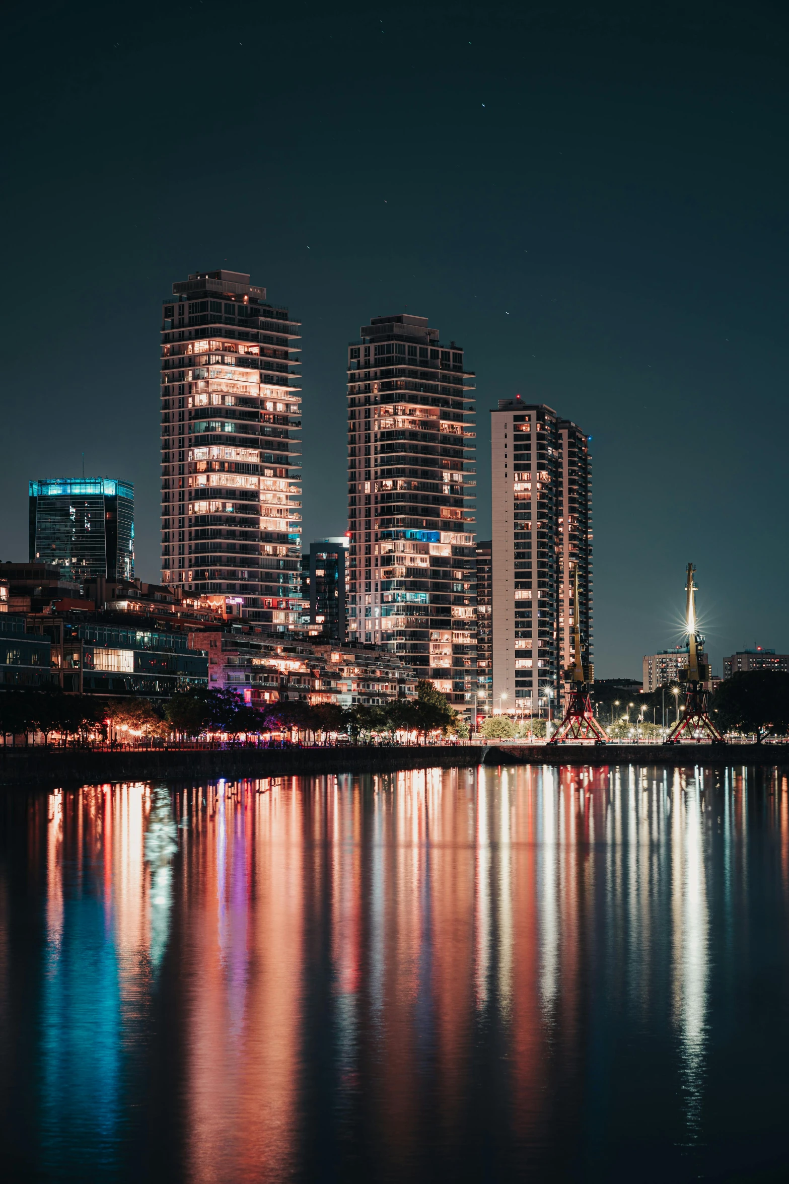 a night scene with a city skyline lit up