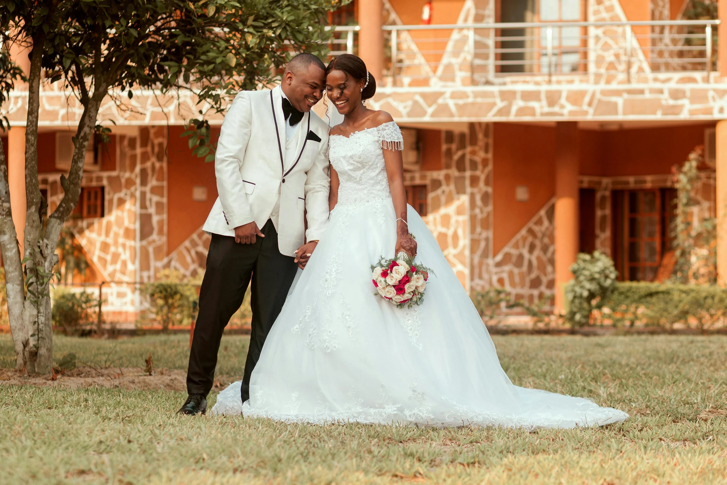 a couple posing for a picture on their wedding day