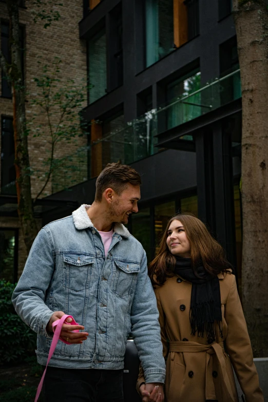 two people walking with a pink frisbee in their hand