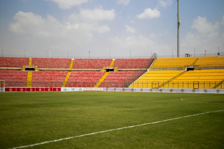 a soccer field filled with yellow and red chairs