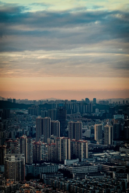 the city skyline from above is seen at sunset