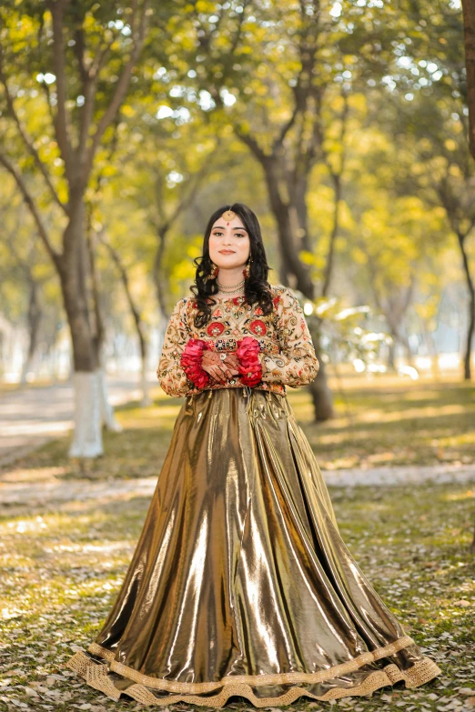 a woman standing in a grassy field holding flowers