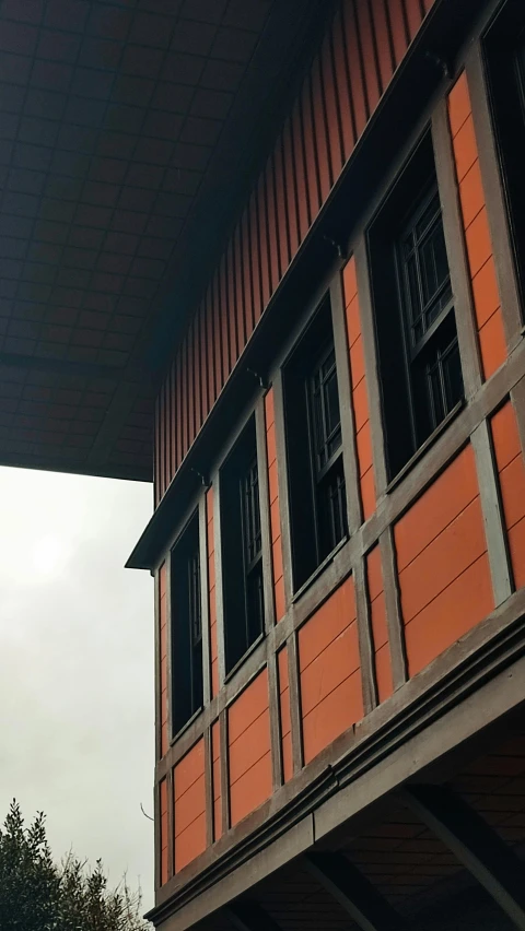 a clock is displayed outside of a brick building