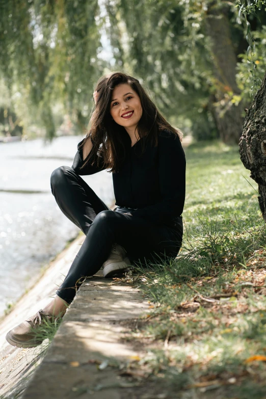 a  sitting on a curb near a lake