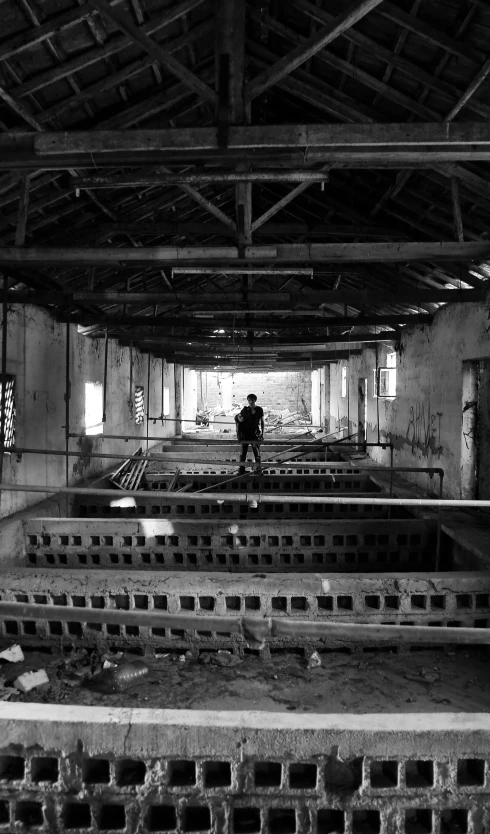 a person walks through an abandoned room with lots of windows