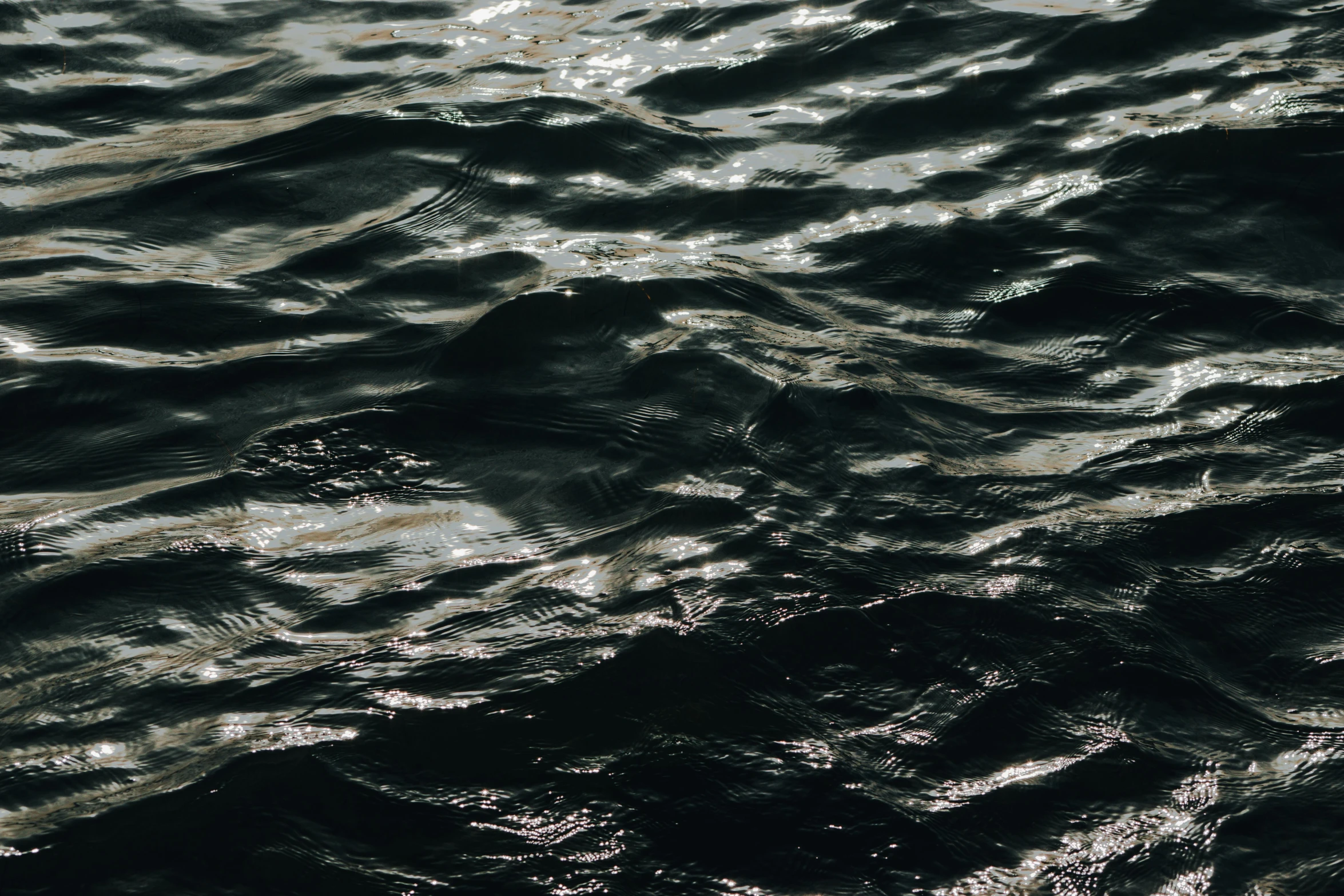 a group of small waves rolling through the water