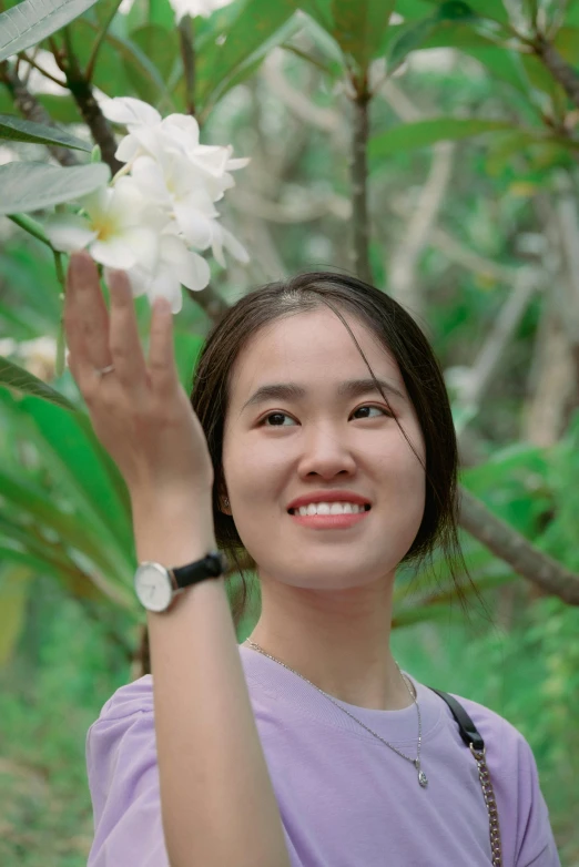a girl holding up a flower in the air