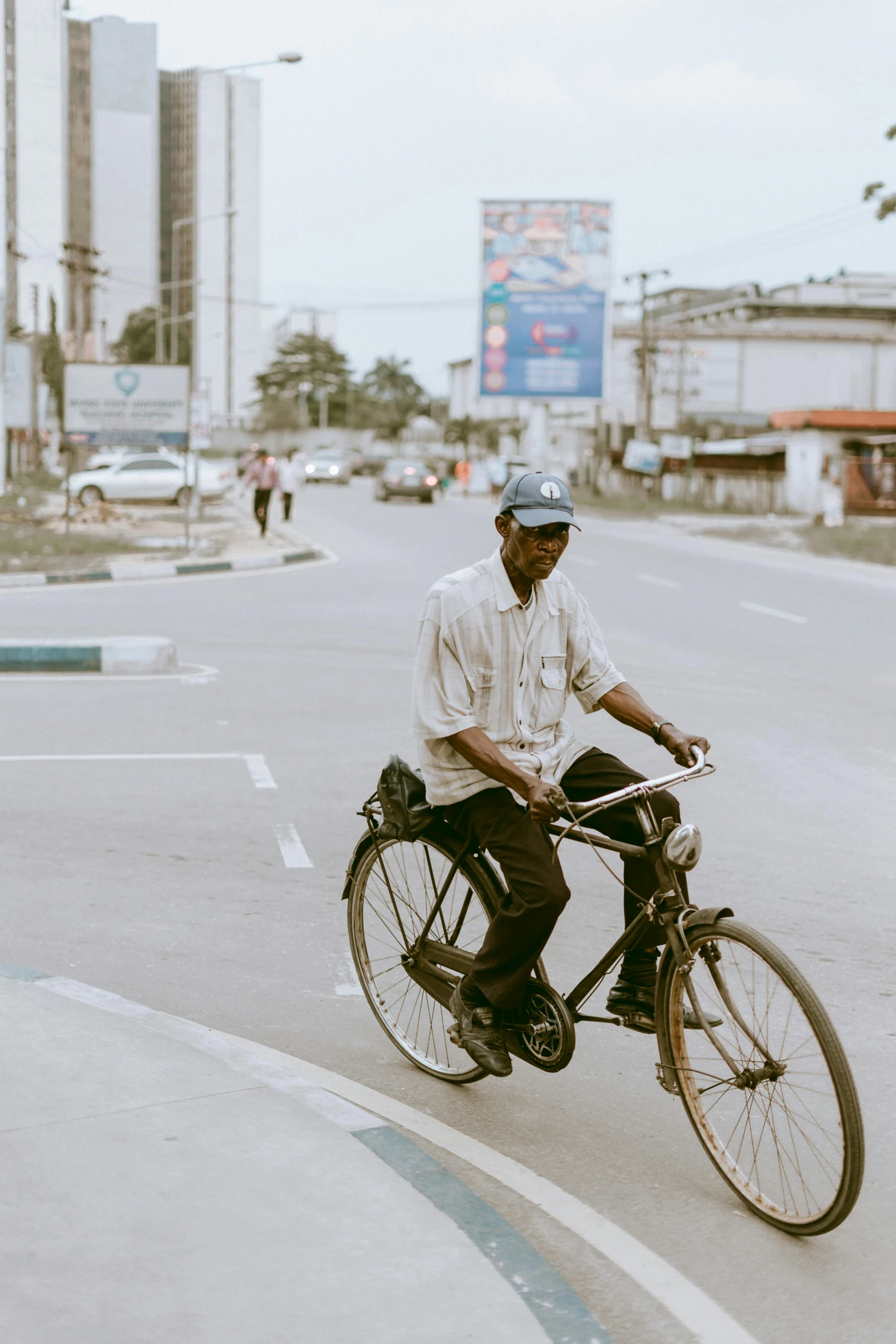 a man rides a bike down the street