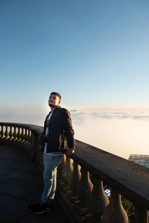 a man posing in front of the railing