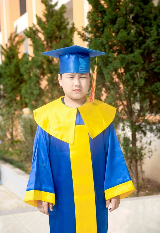 a young child with his graduation hat and gown