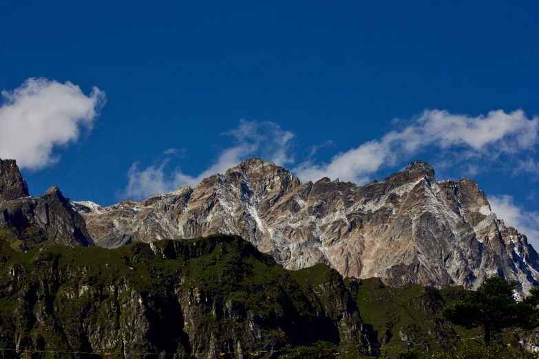 a very tall mountain covered in clouds and trees