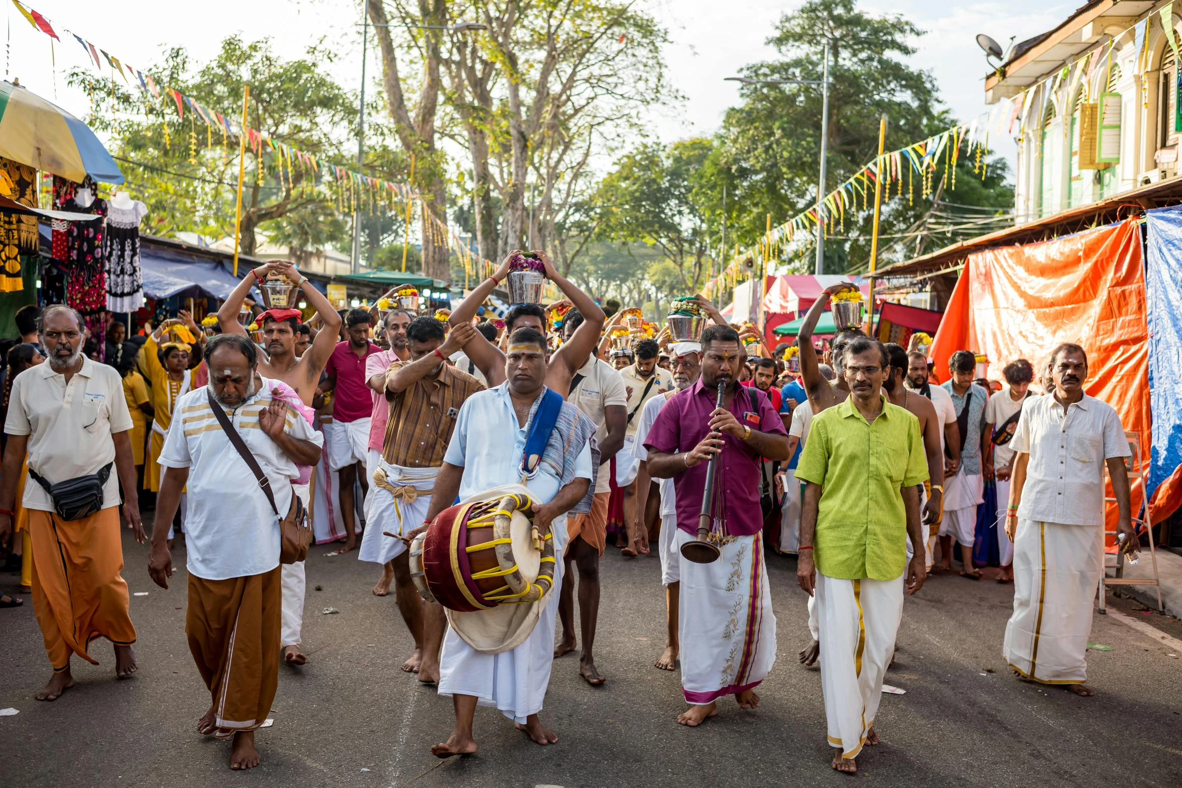 many people are walking around with colorful flags and decorations