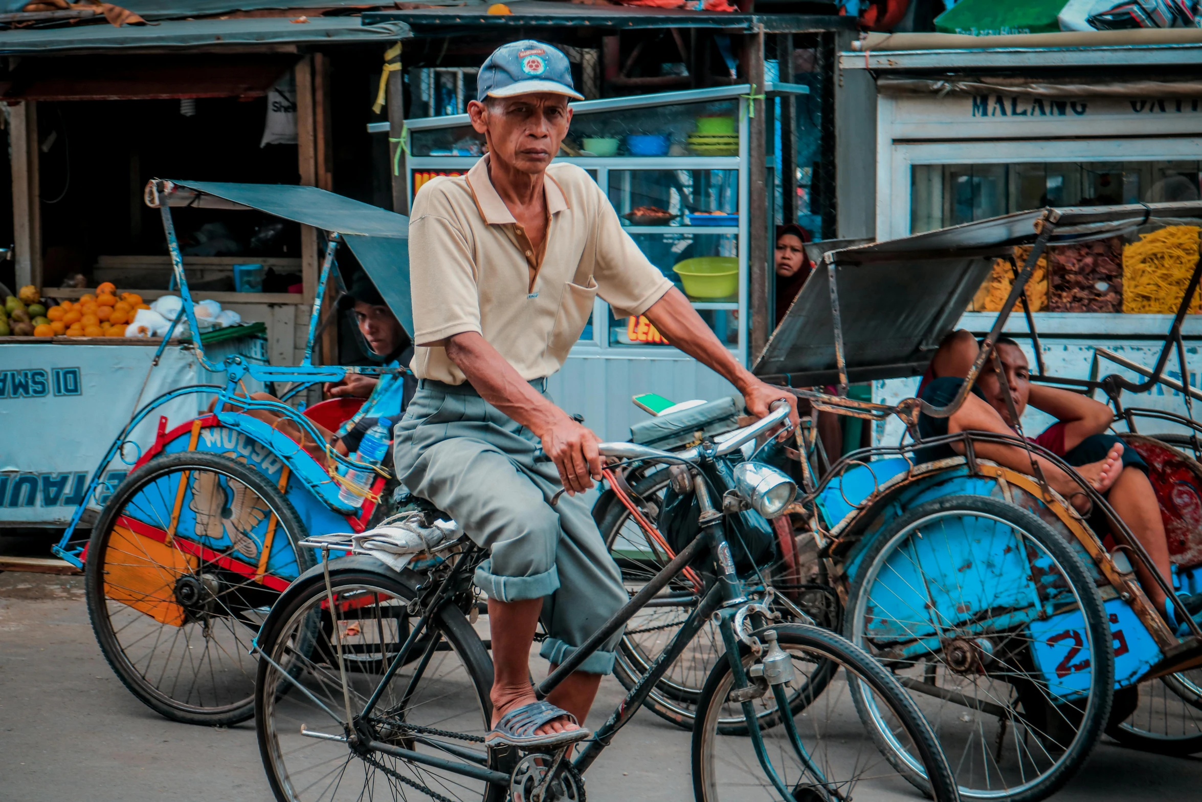 an old man is riding a bicycle near the street