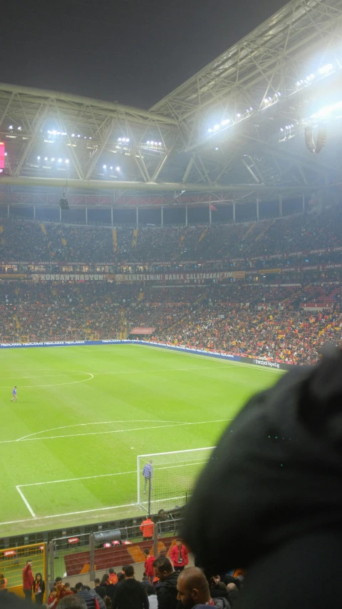 stadium full of spectators sitting on the bleachers watching sports events