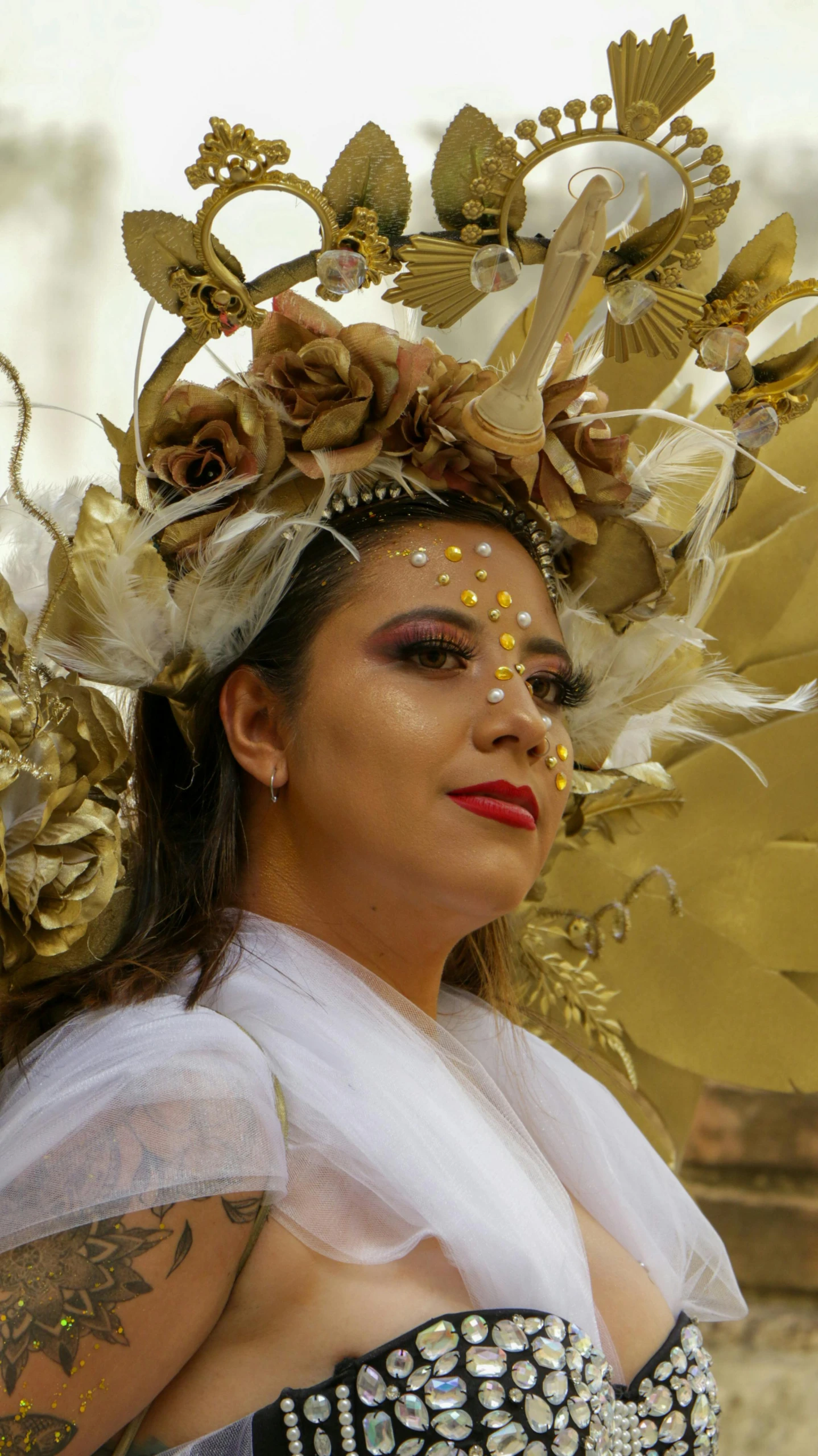 a woman wearing a veil and costume with decorative head pieces