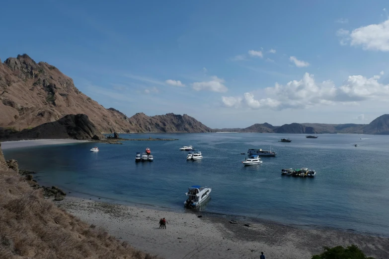 there are many boats in the water on this beach