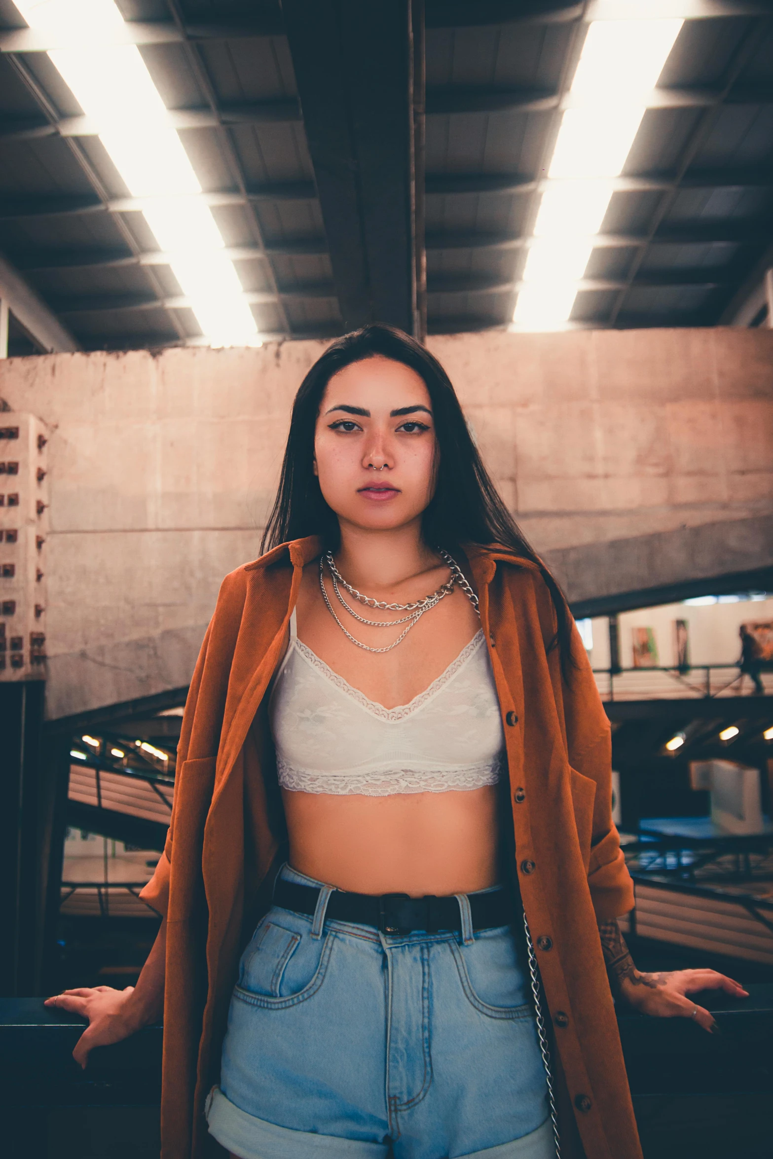 a young woman standing in a parking garage