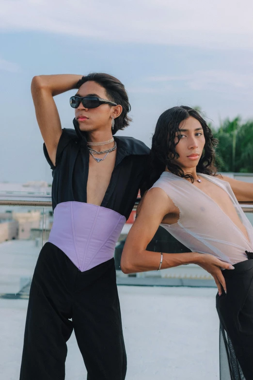 two women wearing matching clothes and sunglasses are posing together