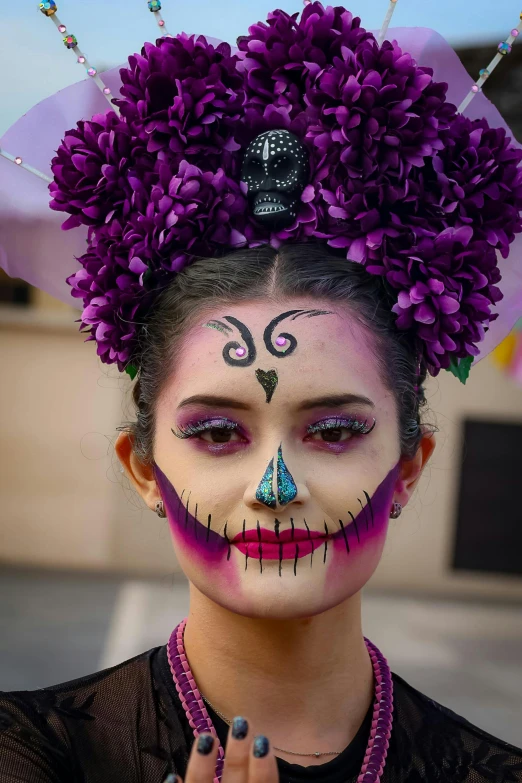 a woman wearing face paint painted like a skeleton