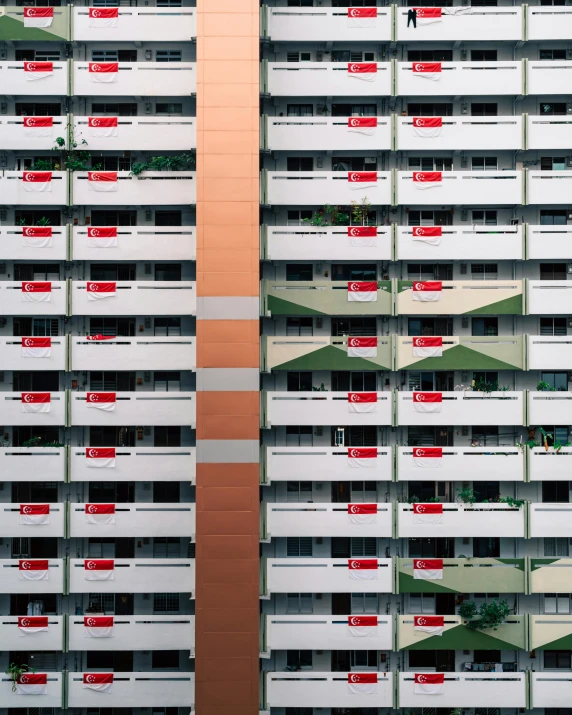 a very tall building with some red and white paint