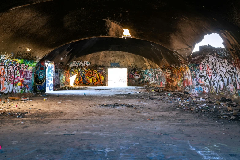 a graffiti covered subway tunnel with lots of spray paint