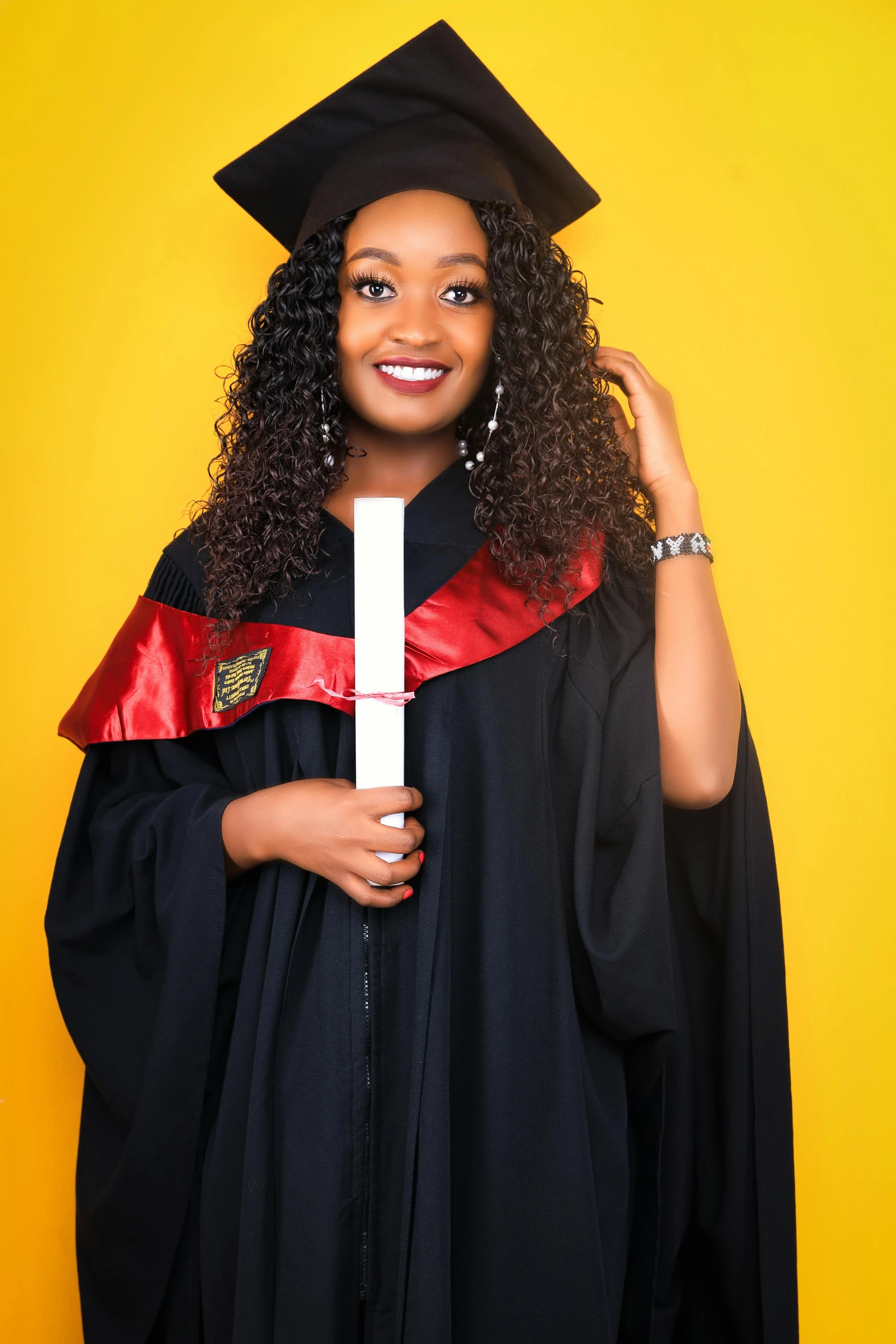 a smiling black graduate poses for a picture