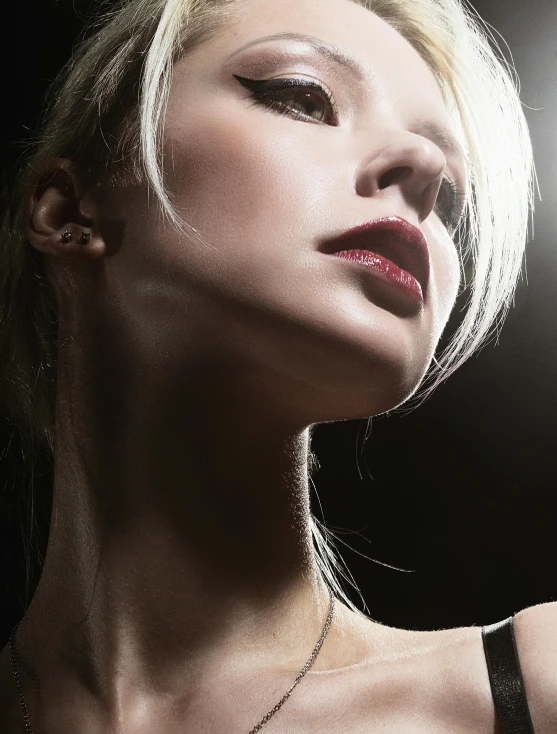 woman in black shirt with earring and white hair