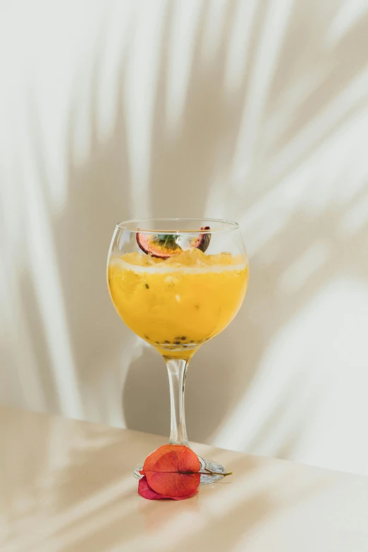 the large drink is on a table beside a small orange slice