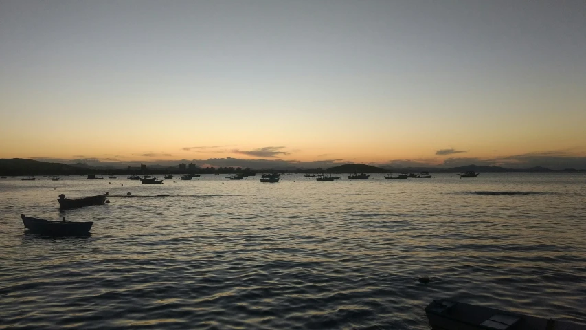 a number of small boats in the water near one another