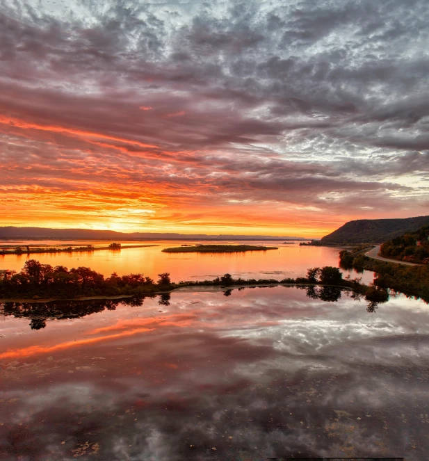 the sky is reflecting in the still water