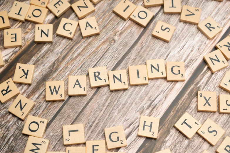 scrabble tiles spell out words like warning, don't close enough