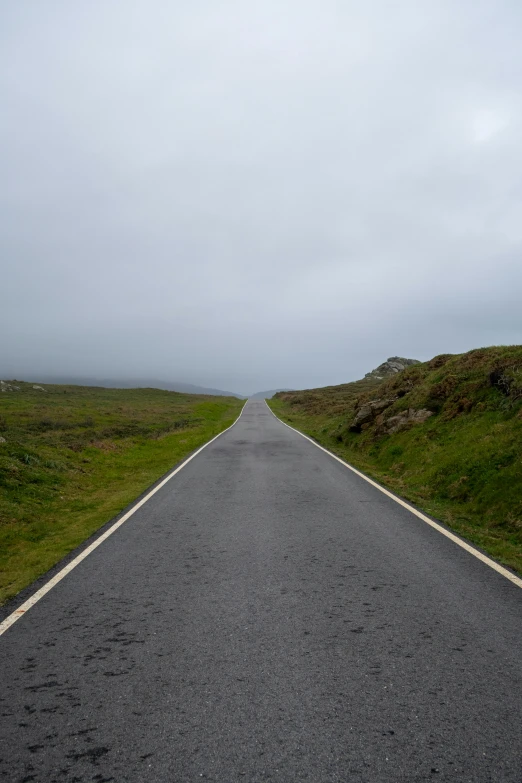 a black asphalt road stretching to the sky