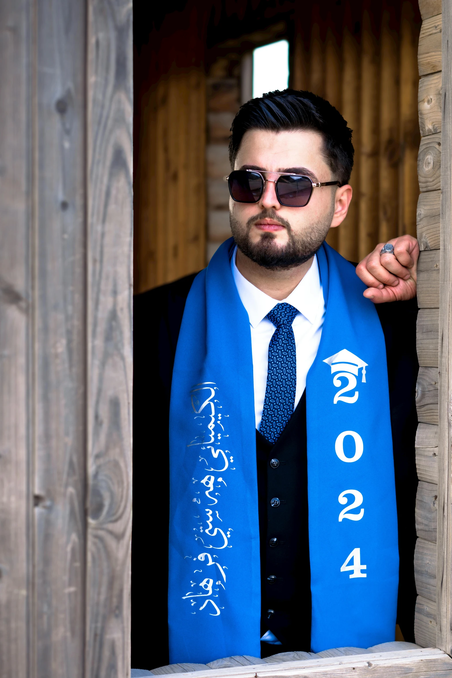 a man wearing sunglasses and a blue scarf