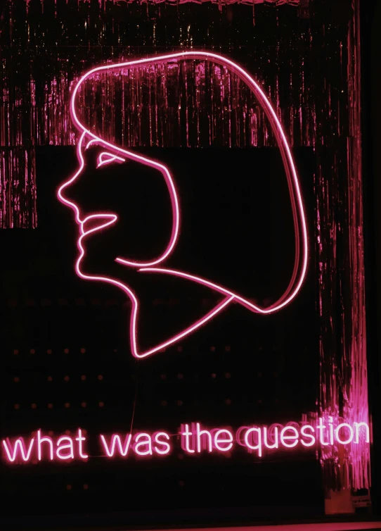 a lighted sign that reads, what was the question?