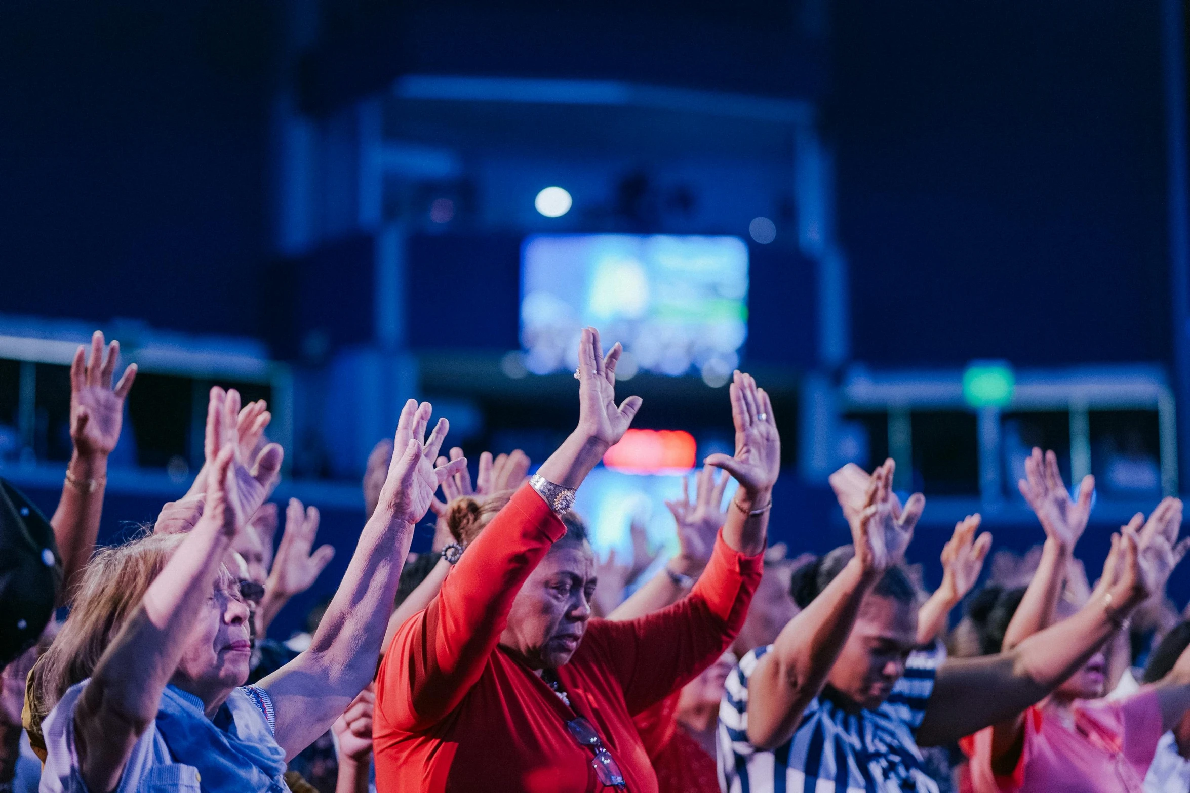 a group of people with their hands raised