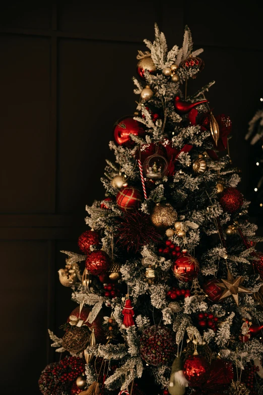 a christmas tree is decorated with gold and red ornaments