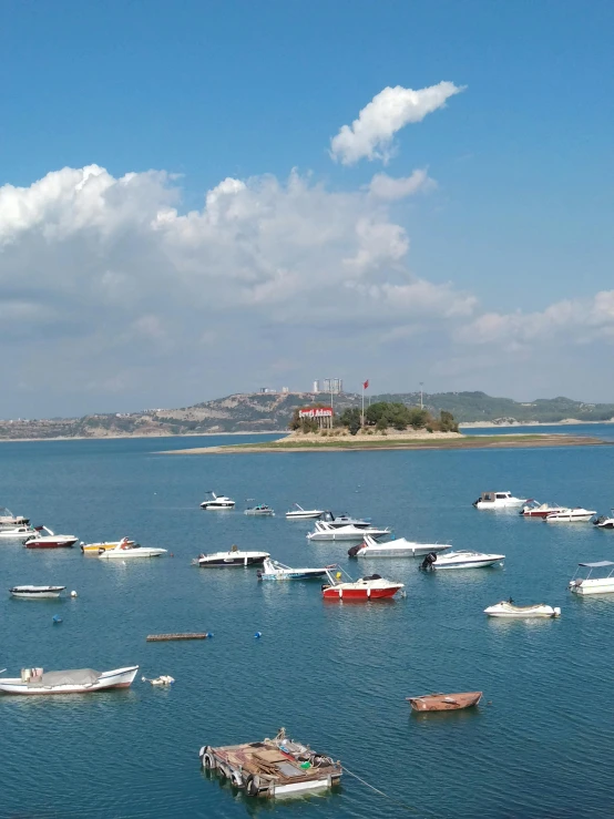 many small boats floating on a large body of water