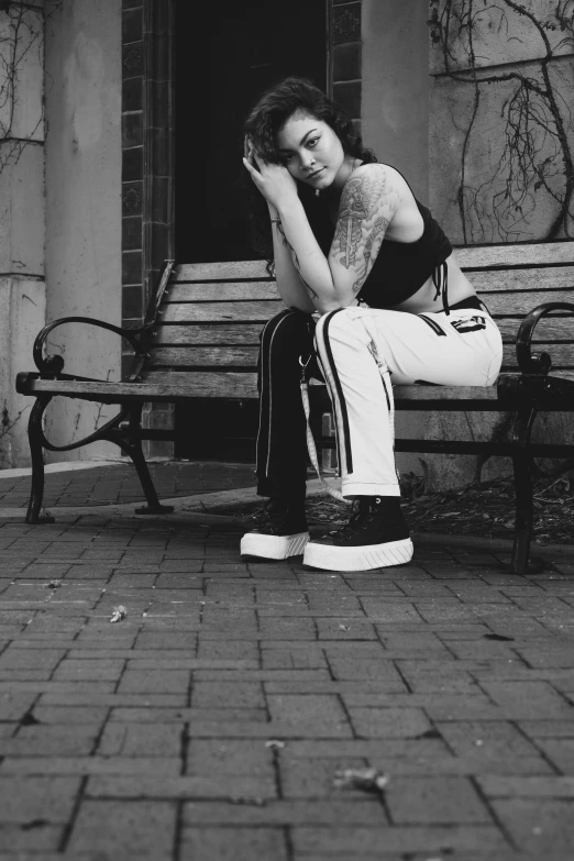 a young woman with her head in her hands on a bench