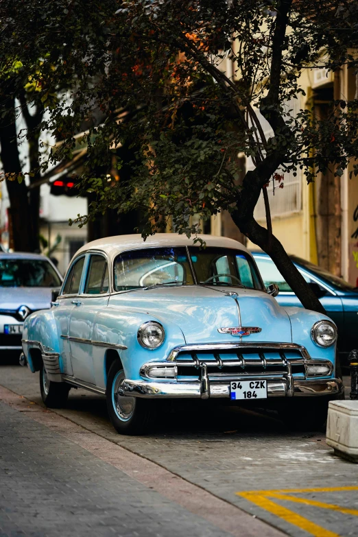 an old car is sitting parked on the curb