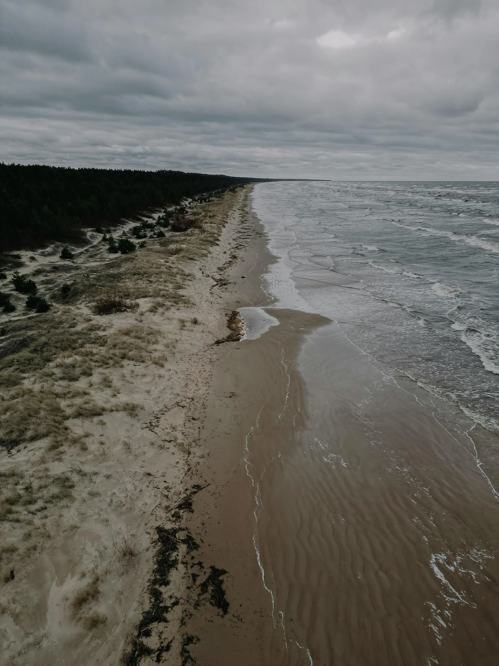 a stretch of shore surrounded by the ocean