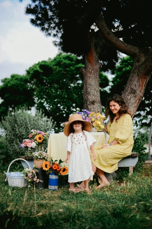 two women and  sitting on a bench outside