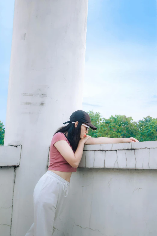 a woman leaning on the ledge of a building