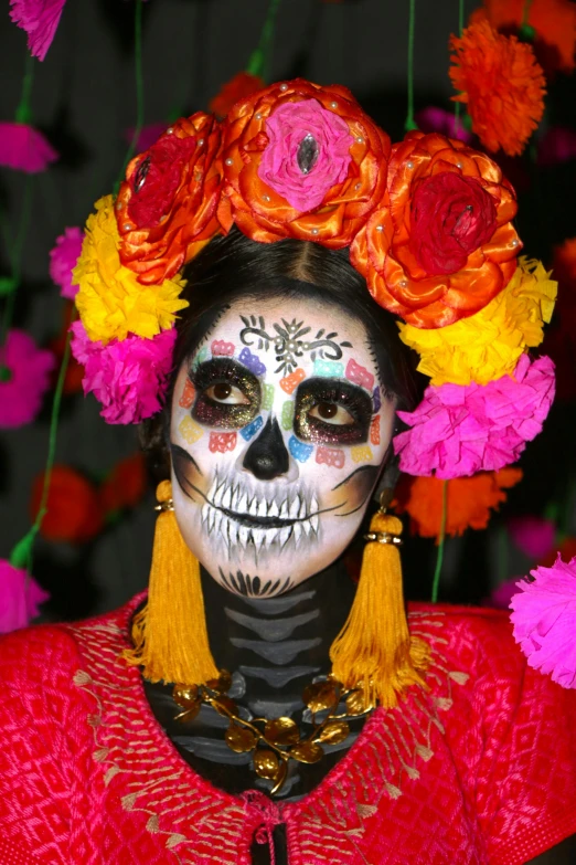 a woman with flowers in her hair painted skull